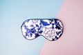 Beautiful silk sleep mask for eyes with flowers pattern on a geometric pink blue background