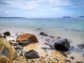 The beautiful silky smooth water waves and rocks on the sea shore. Royalty Free Stock Photo