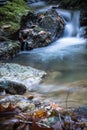 Beautiful silky soft river waterfalls flowing in autumn scenery forest Royalty Free Stock Photo