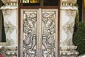 Beautiful silver door leaves with carved silver angels image. Thai style patterned on door leaves made of silver and glass with an