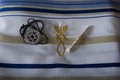 A beautiful Silver Magen David star necklaces on a white tallit with the Malchai 4:2 verses on it. Royalty Free Stock Photo