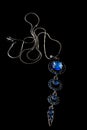 Beautiful silver pendant with blue stones and chain isolated on black background Royalty Free Stock Photo