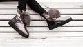 Beautiful silver shiny winter shoes with gray fur on female legs. New collection of fashionable warm glamorous boots. Modern Royalty Free Stock Photo