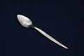 A beautiful silver spoon on black background. Closeup Royalty Free Stock Photo