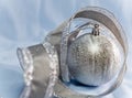 Beautiful silvery New Year ball and elegant tinsel