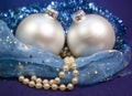 Beautiful silvery New Year`s ball, brilliant tinsel and a pearl beads on a blue background - New Year`s composition, a card Royalty Free Stock Photo