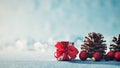 Beautiful simple Christmas background with copy space. Cute Christmas present, red ornaments and pine cones on blue background. Royalty Free Stock Photo