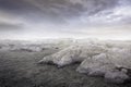 Beautiful simple dark gravel rocks background with mist and clouds