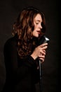 Beautiful singer singing with microphone Royalty Free Stock Photo