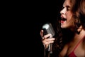 Beautiful singer singing with microphone Royalty Free Stock Photo