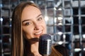 Beautiful Singing Girl. Beauty Woman with Microphone. Glamour Model Singer. Karaoke song. Royalty Free Stock Photo