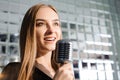 Beautiful Singing Girl. Beauty Woman with Microphone. Glamour Model Singer. Karaoke song. Royalty Free Stock Photo