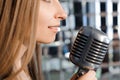 Beautiful Singing Girl. Beauty Woman with Microphone. Glamour Model Singer. Karaoke song. Royalty Free Stock Photo