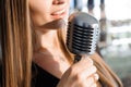 Beautiful Singing Girl. Beauty Woman with Microphone. Glamour Model Singer. Karaoke song Royalty Free Stock Photo