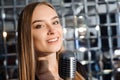 Beautiful Singing Girl. Beauty Woman with Microphone. Glamour Model Singer. Karaoke song. Royalty Free Stock Photo