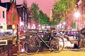 The beautiful sity landscape with bike on the bridge in evening Amsterdam Royalty Free Stock Photo