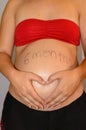 Beautiful six month pregnant woman showing her tummy drawing a heart on it with her hands. June 25, 2019. Madrid. Spain. Royalty Free Stock Photo