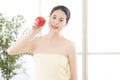 Beautiful skin asian woman towel wrap holding fresh apple