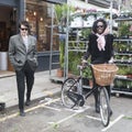 Beautiful skinny tall girl model in a scarf with bicycle at Columbia road flower market