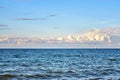 Beautiful sky with clouds over the Baltic Sea. With sailboat and industrial ship in the background Royalty Free Stock Photo