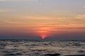 Beautiful sky colorful sunset on the ocean, natural landscapes. Deserted beach, the sun sets in the clouds above the sea