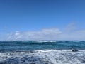 Beautiful sky over the ocean with waves rolling towards the shore on the North Shore Royalty Free Stock Photo