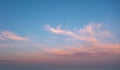 A beautiful sky painted by the sun leaving vibrant gold and pink hues. Clouds in the twilight sky in the evening. Image of a Royalty Free Stock Photo
