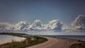 Beautiful sky and perfect road going through Danish countryside.