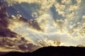 Beautiful sky with sunbeams and dynamic clouds at sunset. Royalty Free Stock Photo