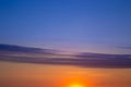 The beautiful sky at sunset is divided by a strip of clouds into two halves of different colors. Sky background Royalty Free Stock Photo