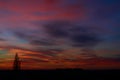 Beautiful sky at sunset with original colours three houses and a tree.