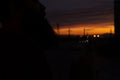 Beautiful sky at sunset with towering towers, against the background of a bearded man smokes