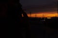 Beautiful sky at sunset with towering towers, against the background of a bearded man smokes