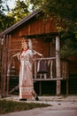 Beautiful Slavic girl with long blonde hair and brown eyes in a white and red embroidered suit and a yoke on her