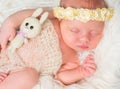 Beautiful sleeping newborn girl with toy and headband Royalty Free Stock Photo