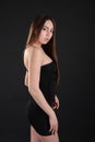 Beautiful slender girl in black short stylish dress Royalty Free Stock Photo