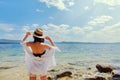 Beautiful slender girl relaxing on the rocky beach of a large lake Royalty Free Stock Photo