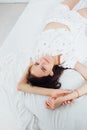 Beautiful slender woman in pajamas lying in the bedroom on the bed Royalty Free Stock Photo