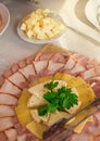 Beautiful sliced food sausage, ham, cheese on a white platter, prepared for guests ` Breakfast in the hotel restaurant Royalty Free Stock Photo