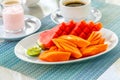 Beautiful sliced fruits in white plate on food table in the morning, artistic Thai style for fruit decoration, healthy Thai fruit