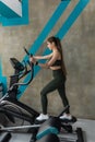 Beautiful slim caucasian woman doing cardio exercise on stationary bike in gym Royalty Free Stock Photo