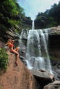 Beautiful slim fitness model posing in front of waterfalls Royalty Free Stock Photo