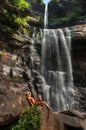 Beautiful slim fitness model posing in front of waterfalls Royalty Free Stock Photo