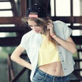 Beautiful slim girl posing on a background of iron structures