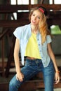 Beautiful slim girl posing on a background of iron structures