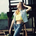 Beautiful slim girl posing on a background of iron structures