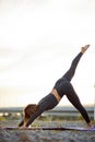 Beautiful slim sporty woman in yoga pose outdoors in city Royalty Free Stock Photo