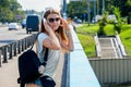 Beautiful slim stylish girl student stands on the car bridge and Royalty Free Stock Photo