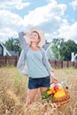 Beautiful slim woman feeling free and calm while standing in the wheat field Royalty Free Stock Photo