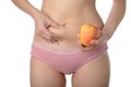 Beautiful slim woman holding apple while checking her fat,Diet c Royalty Free Stock Photo